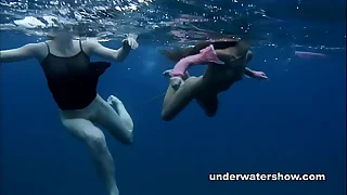 Nastya and Masha are swimming nude in chum around with annoy sea